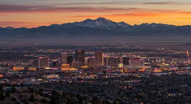 city-skyline-at-twilight-with-mountain-range-backdrop-free-photo